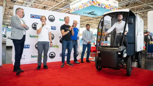 IAA Hannover 2024: Winners of the "Cargobike of the Year" award are on stage. A rider is driving the Cargo PACK