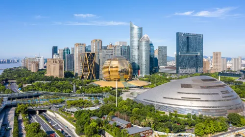 View of Hangzhou skyline, green parks and modern buildings.